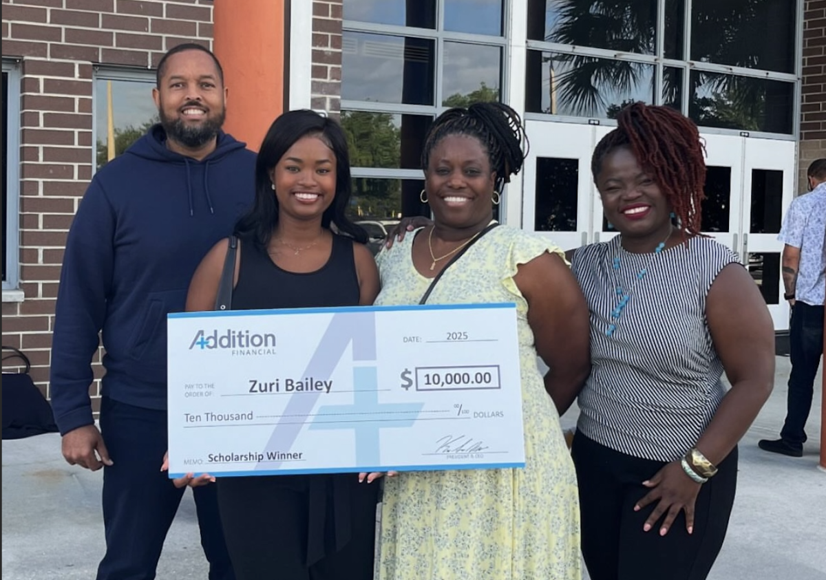 Senior Zuri Bailey poses with a check from Addition Financial. Over 70 students were recognized on May 1 at the scholarship breakfast. Photo by Zuri Bailey.